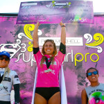 Surfer Sage Erickson, center, looks to defend her Supergirl Pro crown this weekend in Oceanside. She won the contest last year in front of family and friends. Photo by John Alvarea