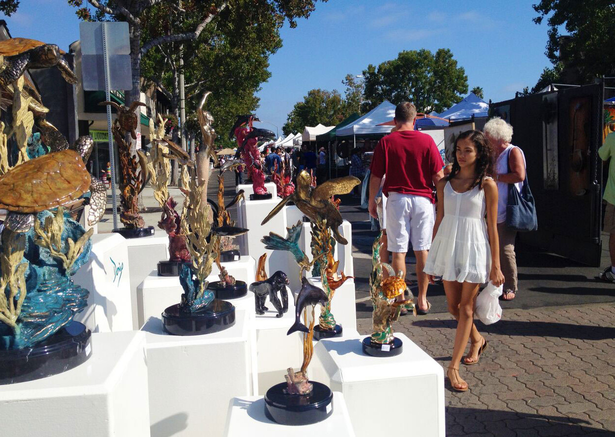 A passerby admires a sculpture at last year’s Art in the Village, which takes place the second Sunday of every August. Courtesy photo