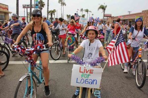 The Live 4 Logan bike coalition takes part in the Independence Parade on Saturday. The group rides to remember Logan Lipton and call for safe streets to bike.