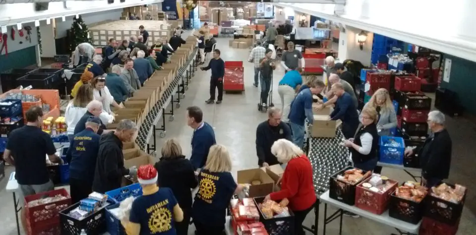 Encinitas Rotary Club working to pack holiday food boxes at an event for the Community Resource Center.
