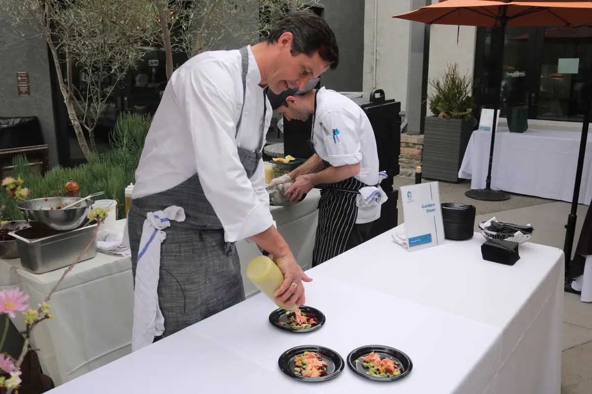 Golden Door's Executive Chef Greg Frey Jr. prepares plates of seafood for guests at the 25th annual Meet the Chefs fundraiser on Sunday at the Hilton Del Mar.