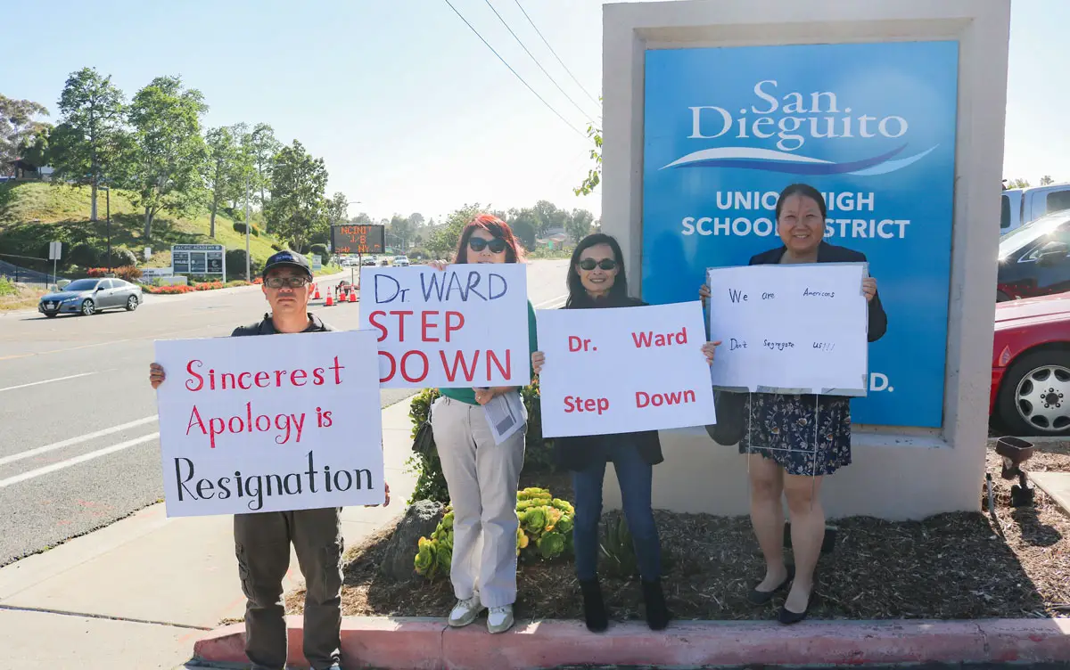 Members of the San Dieguito Union High School District's Chinese-American community, including (from left to right) Charlie Zhao, Jingjin Gao, San Diego Asian Americans for Equality President Joan Chen, and Julie Zou rally for the resignation of Superintendent Dr. Cheryl James Ward outside the district office Wednesday following her comments that Asian students excel in school due to wealthy Chinese families coming to the United States.