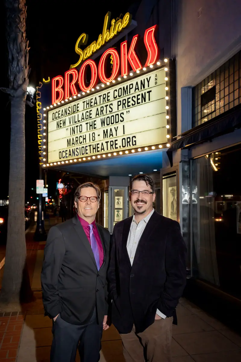 Ted Lieb, artistic director at Oceanside Theater Company, and Alex Goodman, the company's new managing director, stand in front of the historic Sunshine Brooks Theater in Oceanside.