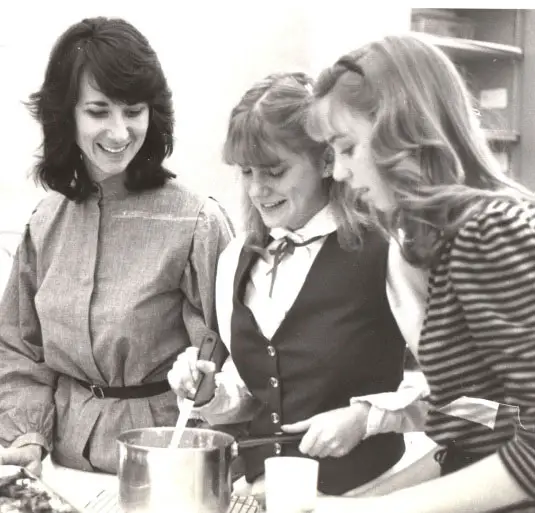 The Barbara J. Dolan Future Center is named for the beloved San Marcos High School educator of 35 years, pictured on the left assisting students during her time at the school. 