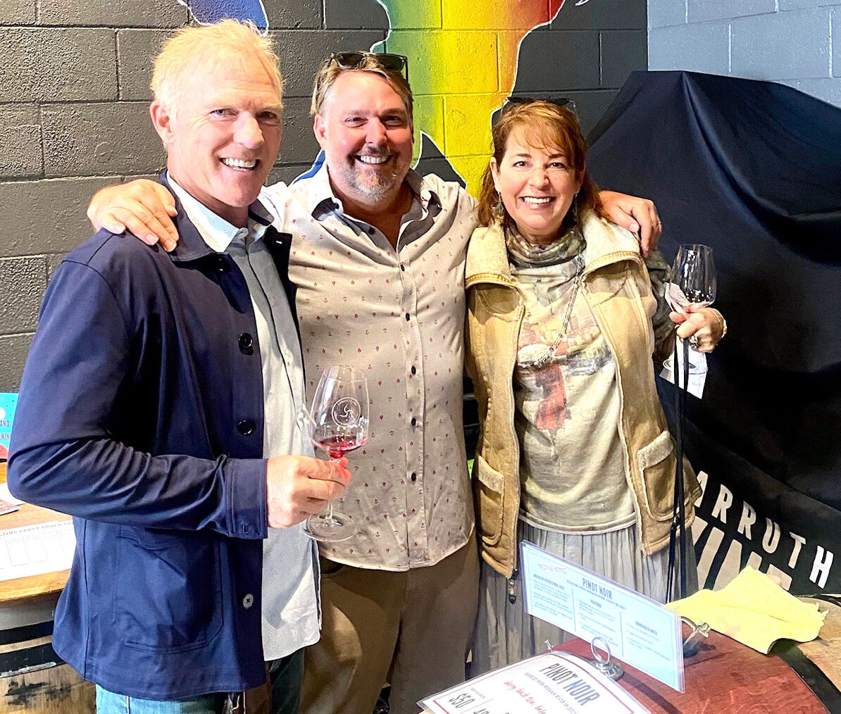 Wine member Keith Greener, from left, Carruth Cellars proprietor Adam Carruth and wine member Debbie Day at the Burgundy station.
