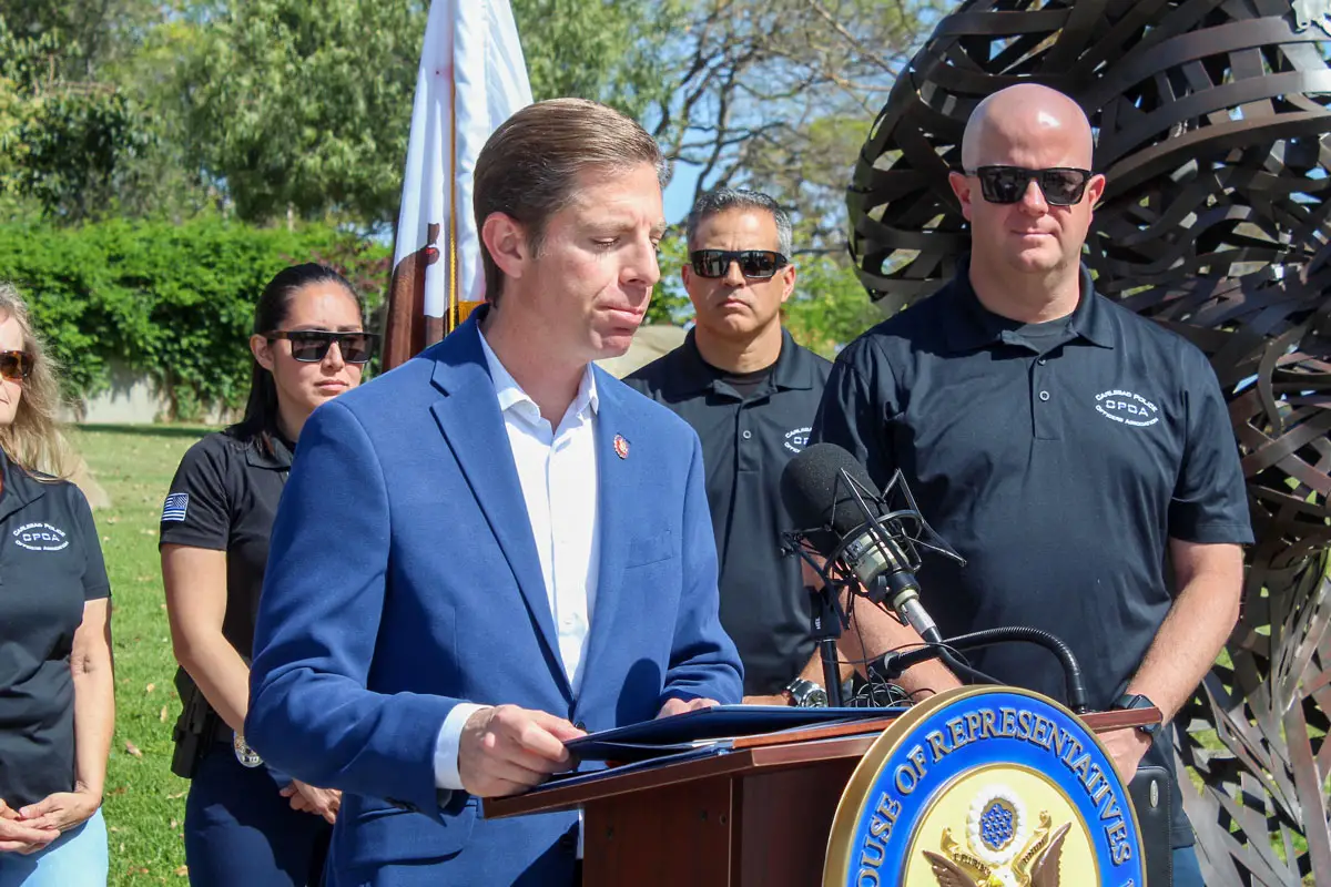 Congressman Mike Levin, left, speaks in support of the Invest to Protect Act during an April 15 press conference at the Carlsbad Police Department headquarters. The bill would establish a grant program of $50 million per year for law enforcement departments with 200 or fewer employees.