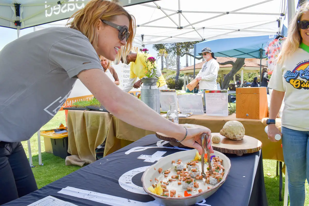 Jessica Waite of The Plot, a plant-based and zero waste restaurant, hands out her ceviche de la tierra plant-based sushi at the Oceanside Earth Festival on April 23.