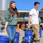 Escondido High School students Georgia Borland, 14, and Joey Serrano, 15, head to the pens to feed their hogs as part of the school's Future Farmers of America program.