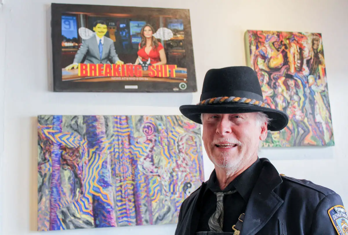 Stephen Frank Gary, a Vista-based artist whose work promotes peace and the First Amendment, stands in front of some of his work at the Backfence Society in Vista.