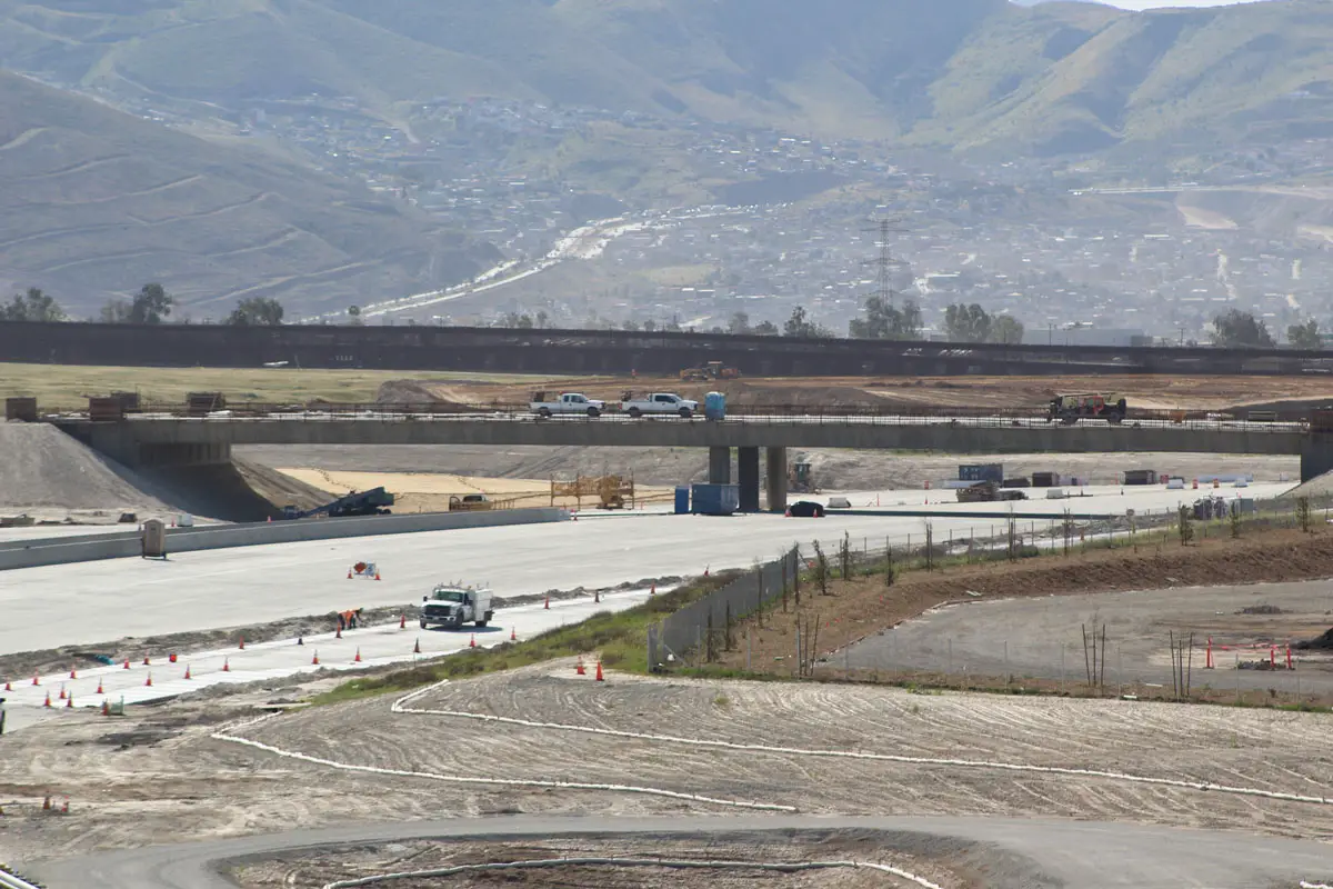 A view south of Otay Mesa to the Mexican border shows construction crews working on the new Otay Mesa East Port of Entry, which is expected to open in September 2024. The $1.1 billion joint project with Mexico will offer a toll for motorists and trucks to offload traffic from San Ysidro and Otay Mesa border crossings. 