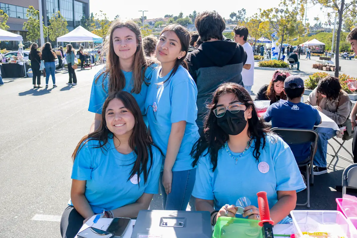 San Marcos High School juniors, from left, Kayla Langis and Isabella Garcia (top row) and Idalis Castillo and Ivelise Moran (bottom row) volunteer during a farmer's market on Saturday, organized as part of their U.S. history class.