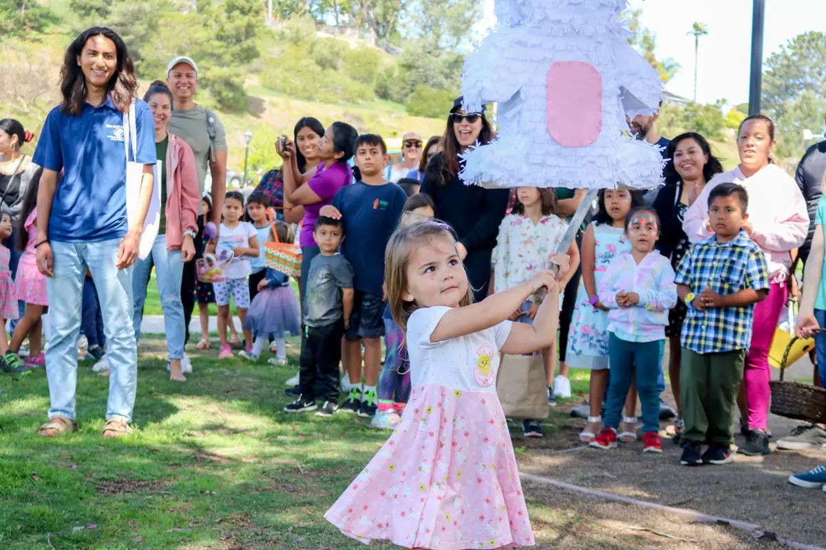 A crowd of kids take their shot at a piñata  on Saturday during the annual Children's Spring Festival at La Colonia Community Park in Solana Beach. 