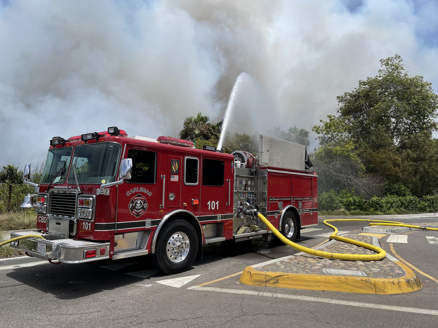 Carlsbad fire: A Carlsbad fire truck and its water cannon blasts a 10-acre brush fire at the Buena Vista Lagoon on June 25. Residents were evacuated within minutes of the fire starting and no injuries were reported. 