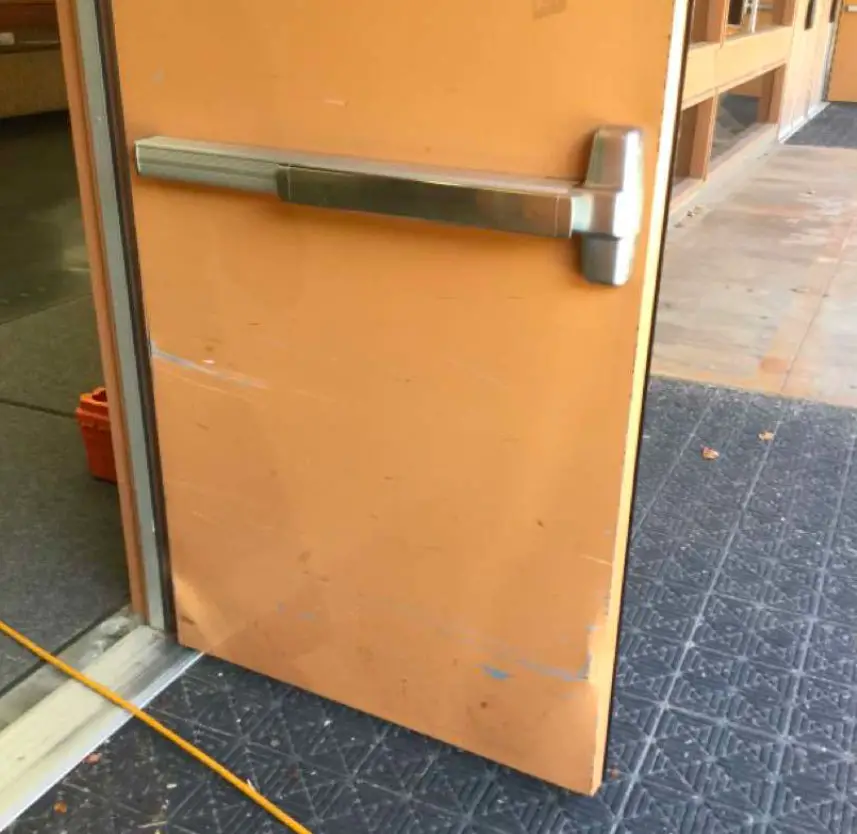 A poorly latching exterior door is missing a seal at Torrey Pines High School. This deficiency, along with others, was deemed the highest priority out of more than $77 million worth of repairs identified in a 2020 maintenance assessment of the San Dieguito Union High School District. Photo via Kitchell report