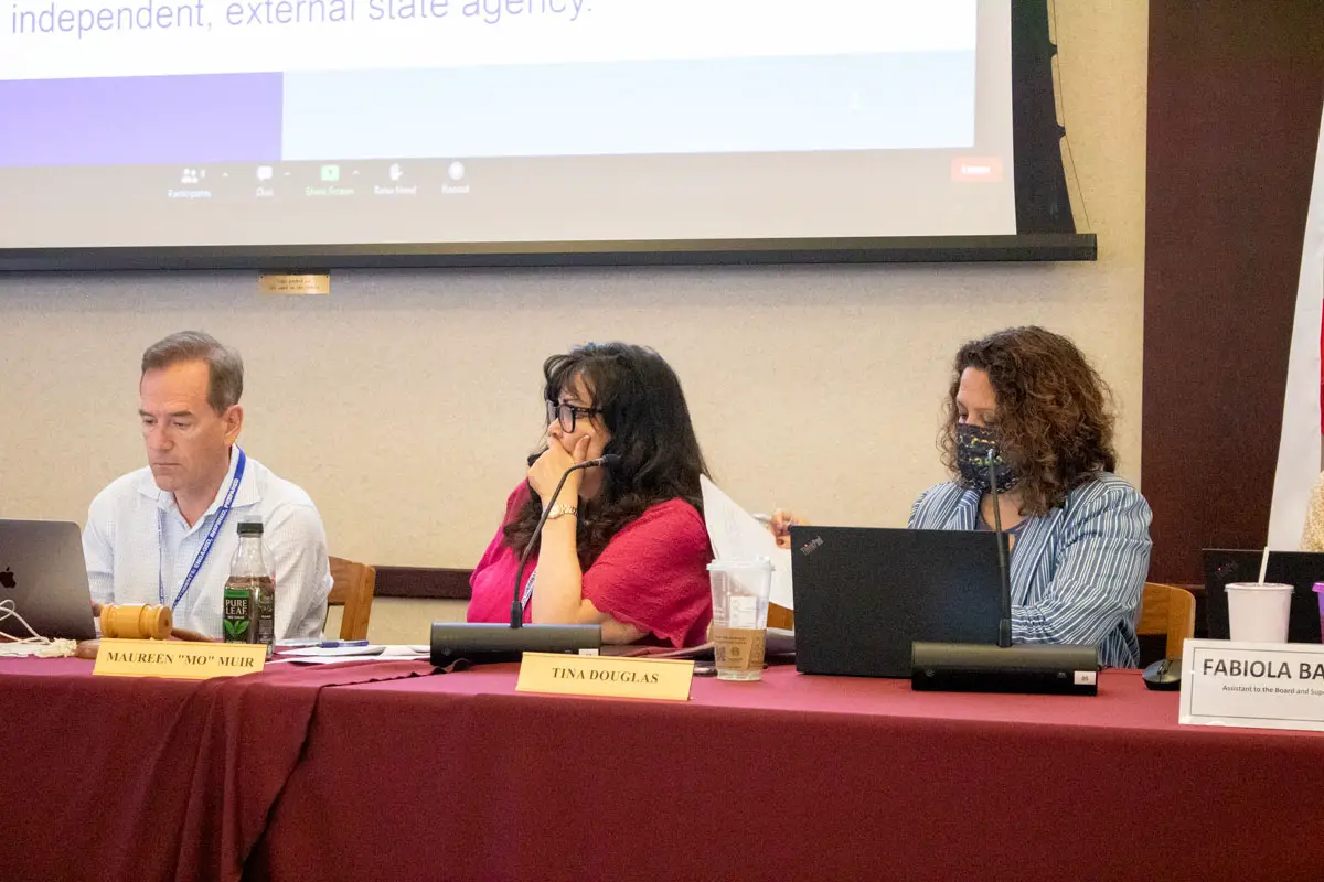 San Dieguito Union High School District trustees Michael Allman, left, and Mo Muir, center, listen to a presentation from the Financial Crisis and Management Assistance Team at the board’s June 23 meeting. At right is Interim Superintendent Tina Douglas. Photo by Laura Place