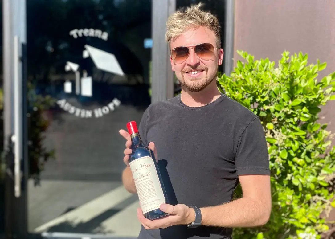 CJ Gormley, brand ambassador at Hope Family Wines, holding a bottle of 2020 Austin Hope cabernet sauvignon. Photo by Rico Cassoni
