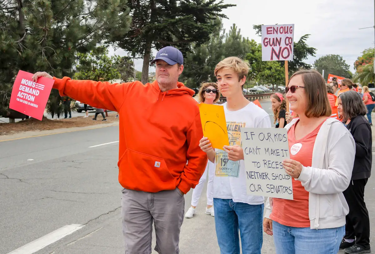 Families and individuals joined North County Moms Demand Action in Encinitas on Saturday for an annual Wear Orange demonstration advocating for gun safety. Photo by Laura Place