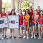 The San Marcos Girls Softball 10U All Star team sells flowers at Albertsons in San Marcos to raise funds for its upcoming trip to Salem, Ore., to compete at Western Nationals. Photo by Laura Place
