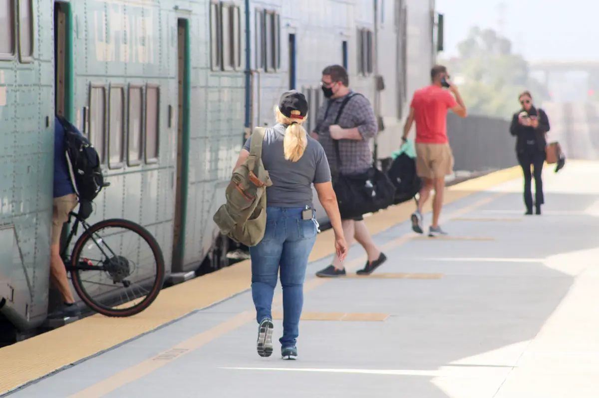 SANDAG road user charge: Passengers board the train on July 18 at the Carlsbad Poinsettia Coaster Station. Photo by Steve Puterski