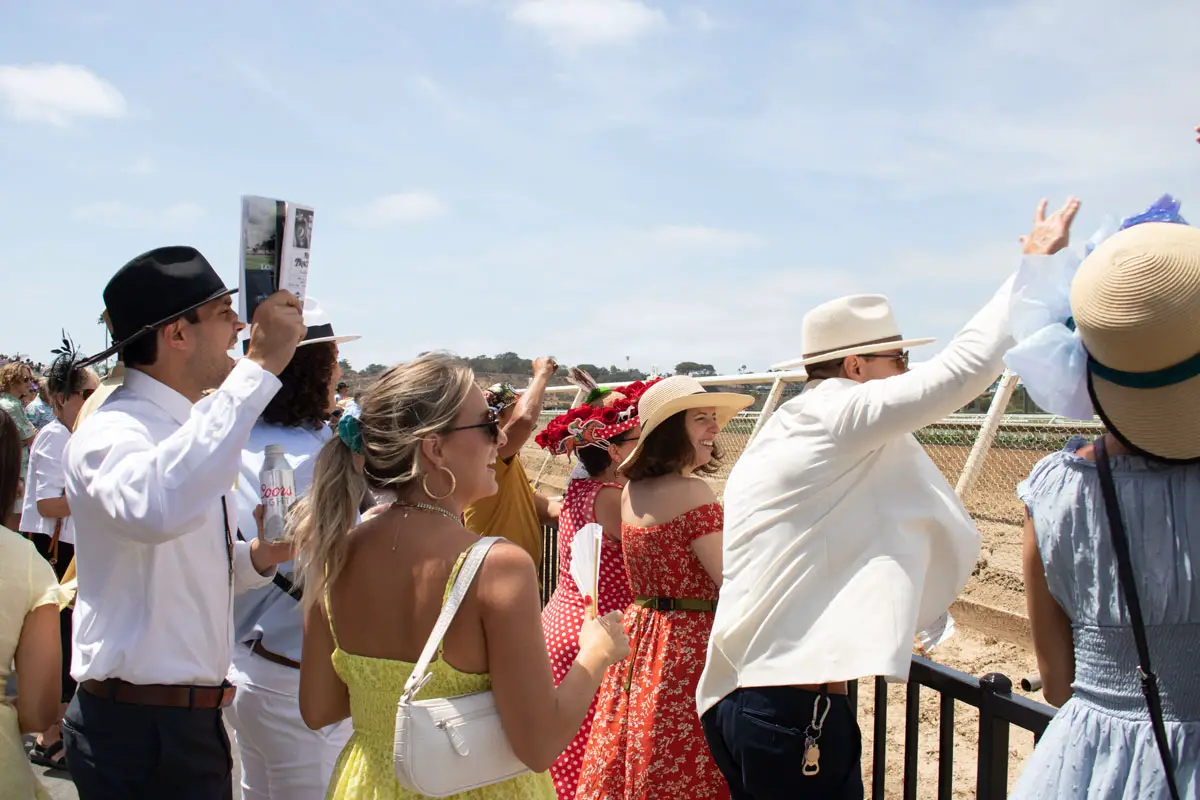 Spectators cheer during the five-furlong turf race on the opening day of Del Mar’s summer meet. Photo by Laura Place