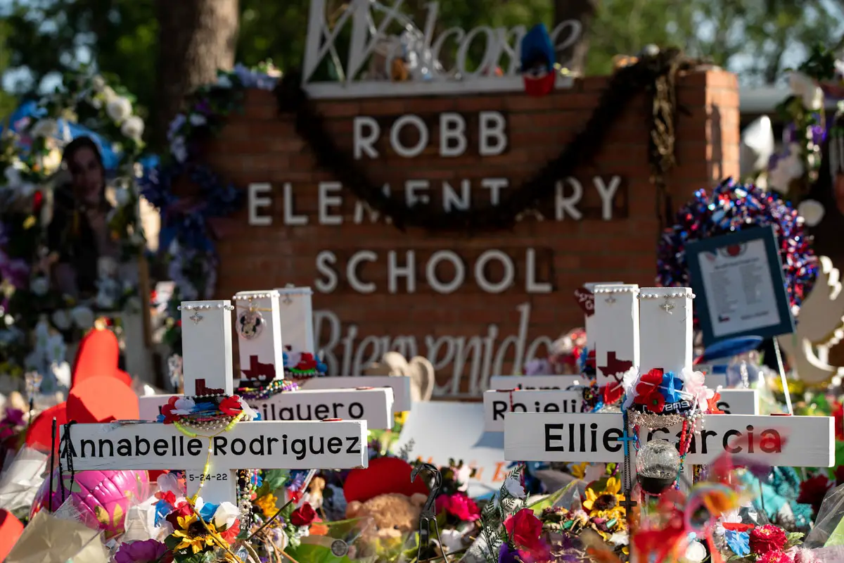 Texans visit the memorial at Robb Elementary School dedicated to the victims of the May shooting in Uvalde, Texas, that left 19 children and two adults dead. Photo by Jinitzail Hernandez