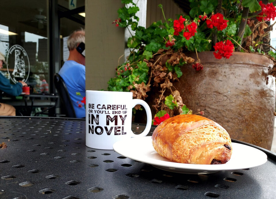A large chocolate croissant and black coffee on the patio at Isabelle Briens French Pastry Cafe in Encinitas. Photo by Ryan Woldt
