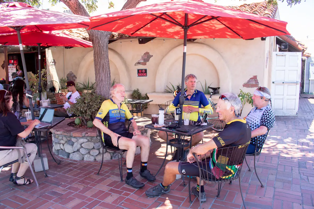 Members of the North County Cycle Club enjoy the shade at Old California Coffee House and Eatery, one of a few remaining businesses at Restaurant Row in San Marcos. Photo by Laura Place