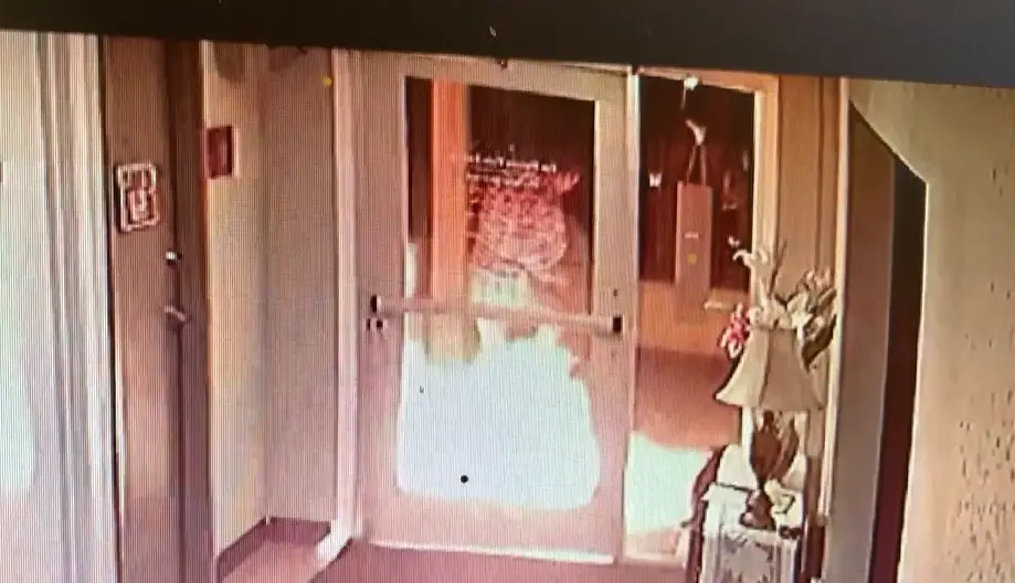 A still from video surveillance shows a man setting a fire on Aug. 10 outside the door of San Marcos View Estates. Courtesy photo
