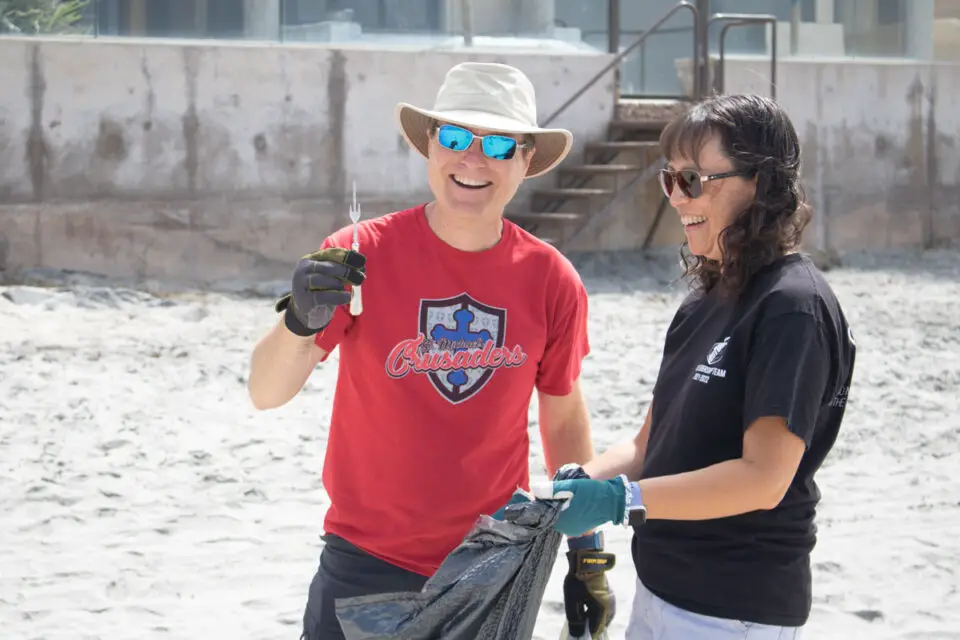 Escondido residents June and Bill Poling collect trash on the beach near Powerhouse Park on Saturday in Del Mar during the 38th annual Coastal Cleanup Day. Photo by Laura Place