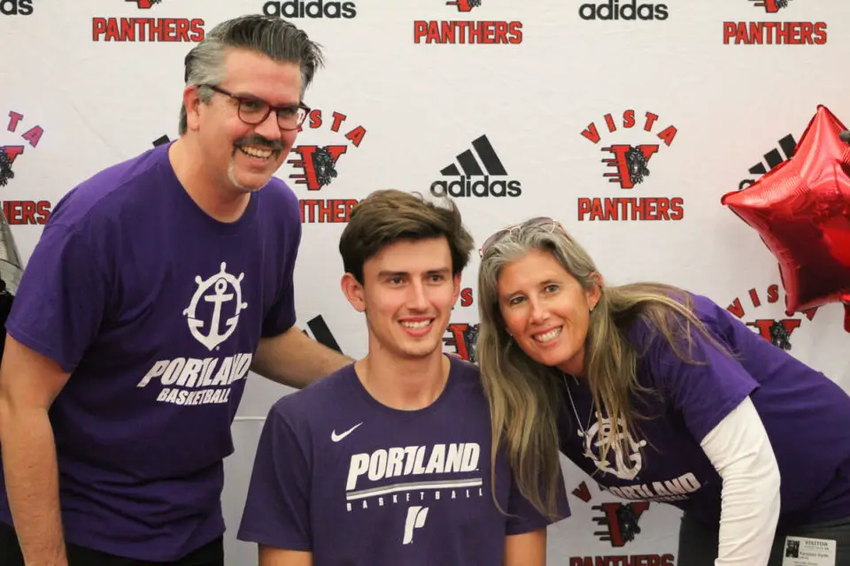 Vista senior Cyprian Hyde, pictured with his mom and dad, signed a letter of intent to play basketball at the University of Portland on Nov. 10 at Vista High School. Photo by Steve Puterski