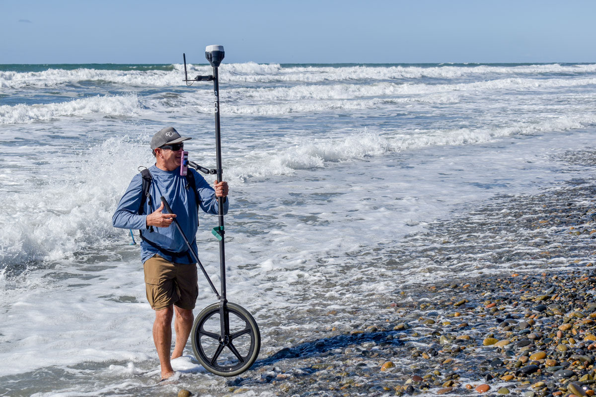 Bob Ashton of Save Oceanside sand walks the GNSS RTK receiver from Scripps out into the water and back, measuring the height of sand. Photo by Samantha Nelson