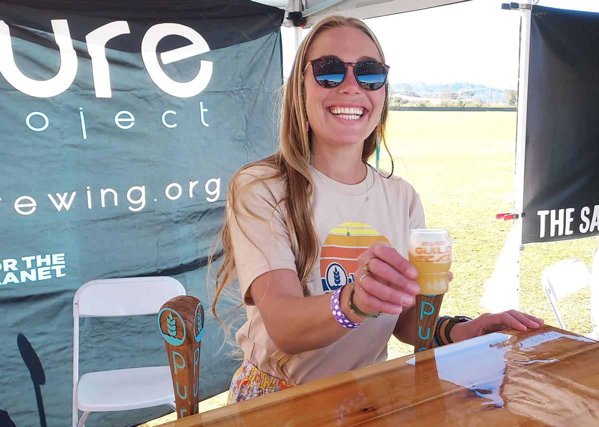 Kylie from Pure Project offers a beer at this year's San Diego Beer Guild Fest. Photo by Ryan Woldt