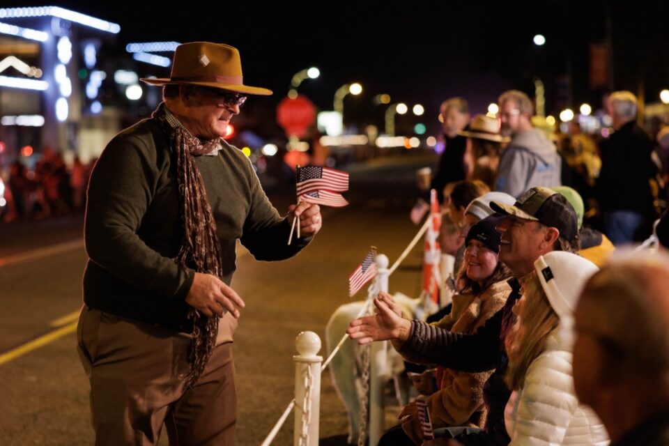 Mayor-elect Tony Kranz hands out miniature American flags during the 60th Encinitas Holiday Parade on Saturday along South Coast Highway 101. Photo by Vlad Medvinsky