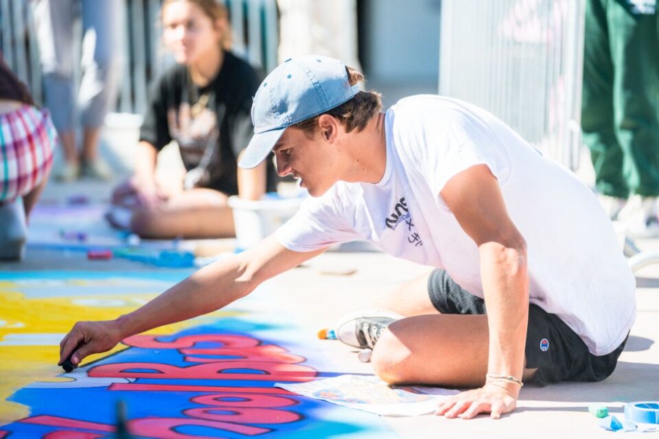 A student artist draws during Santa Fe Christian's annual Chalk Festival. Photo courtesy of Captis Visuals