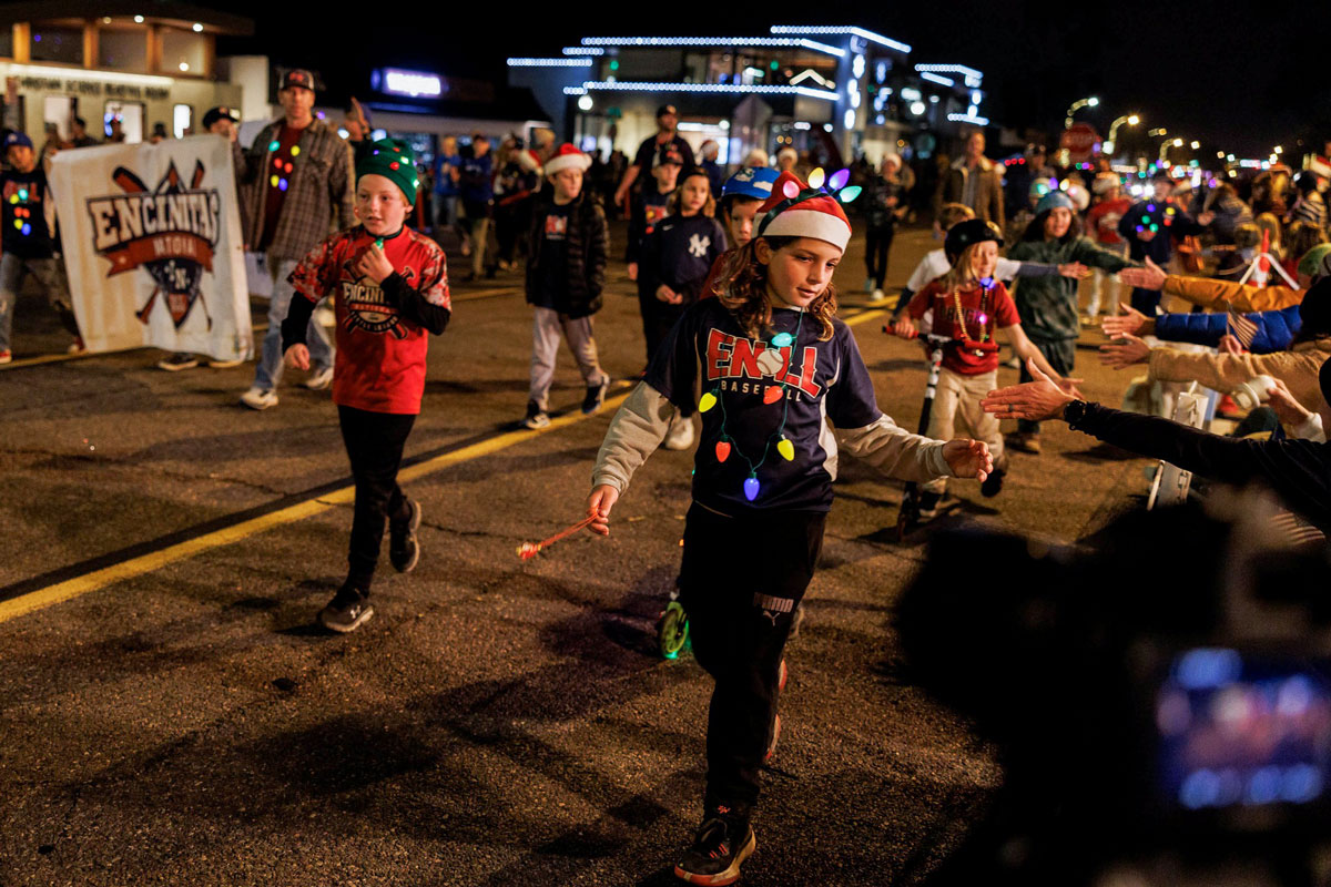 Players with the Encinitas National Little League team participate in the 60th annual Encinitas Holiday Parade on Saturday along Coast Highway 101. Photo by Vladimir Medvinsky