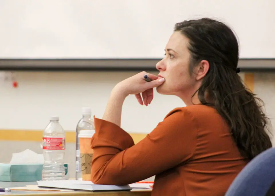 Jade Janks, who has been charged with murdering her stepfather in Solana Beach in 2020, listens to testimony on Thursday at the Superior Court North County Division in Vista alongside defense attorney Marc Carlos. Photo by Laura Place