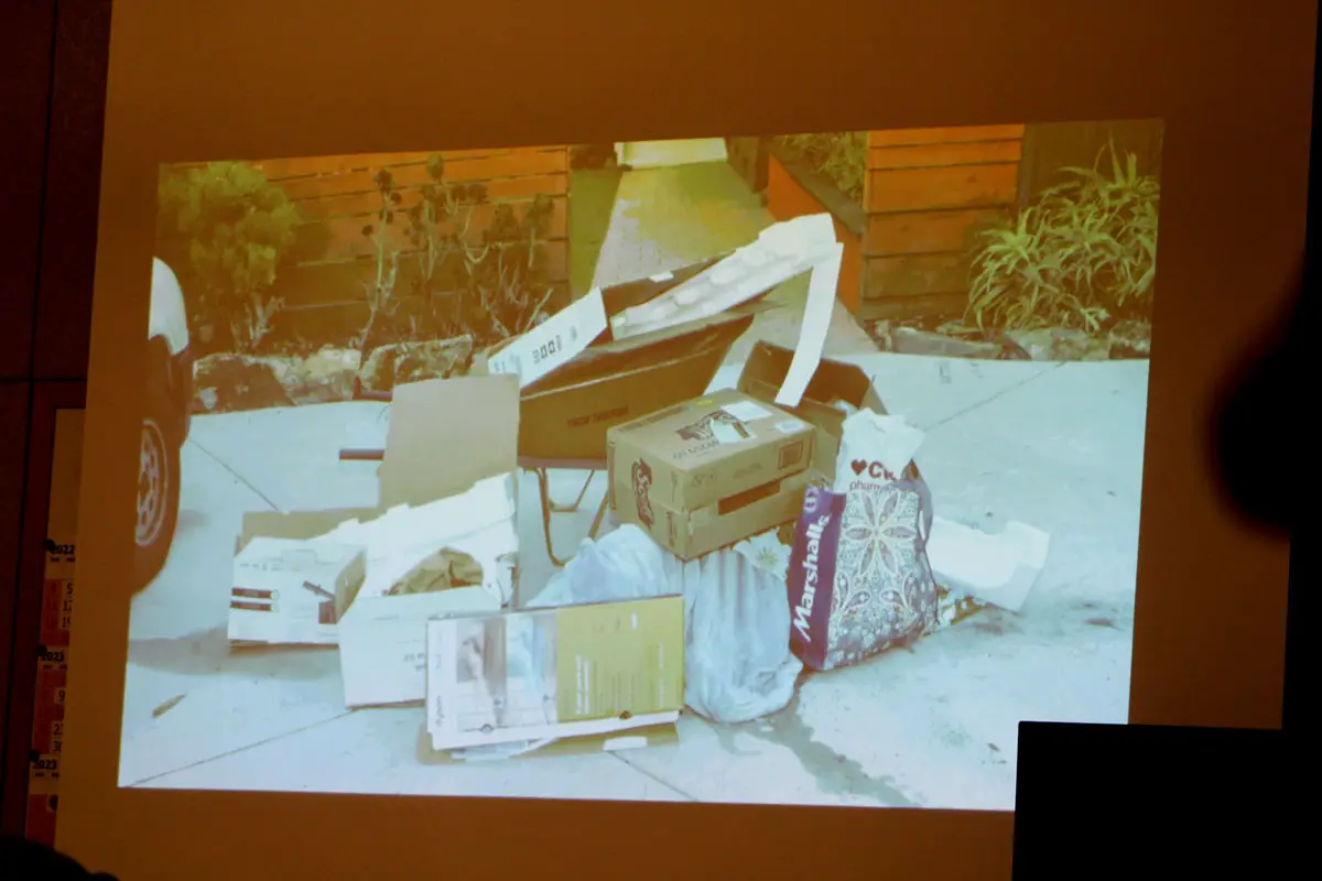 Janks trial: A photo of the pile of trash where Thomas Merriman’s body was discovered in his driveway in Solana Beach on Jan. 2, 2021, is shown to the court in the trial of Jade Janks, who is accused of murdering him. Photo by Laura Place