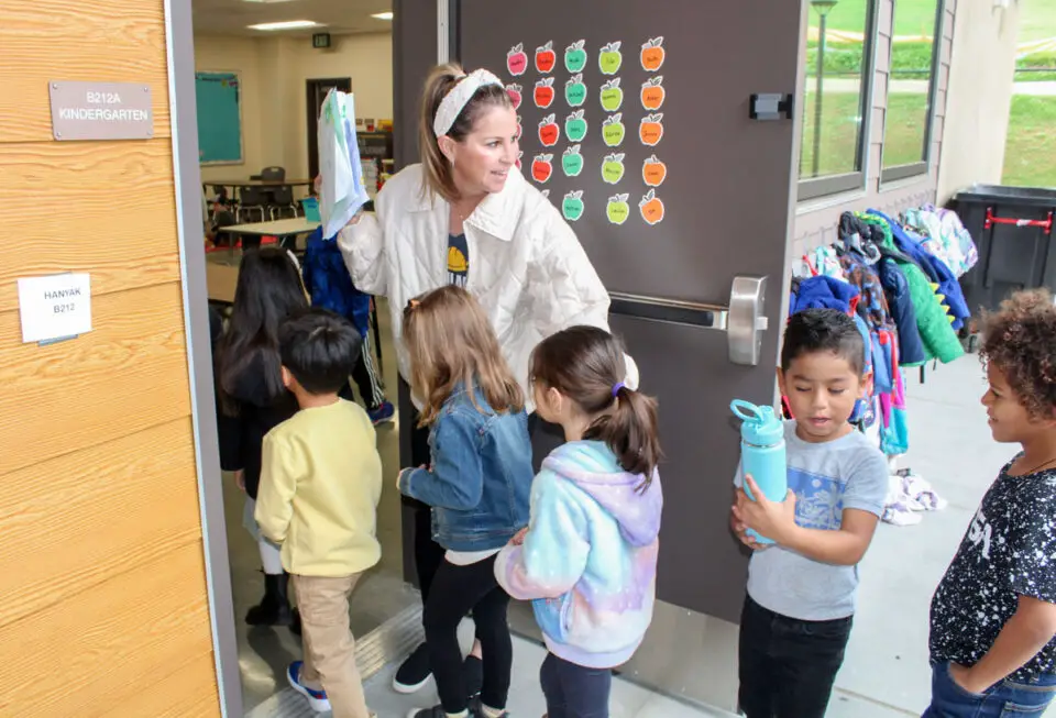 Teacher Ginger Hanyak ushers kindergarten students into their classroom at the new Richland Elementary School campus in San Marcos on Monday. Photo by Laura Place