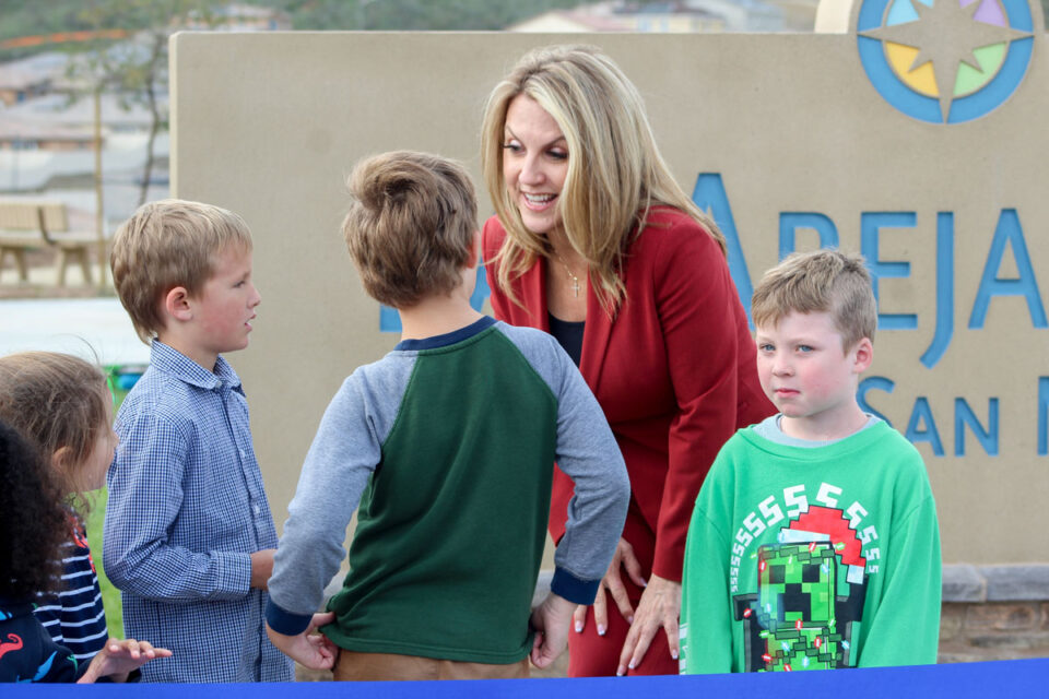 San Marcos Mayor Rebecca Jones talks to local children at the grand opening of Las Abejas Park on Monday along Woodhaven Road. Photo by Laura Place