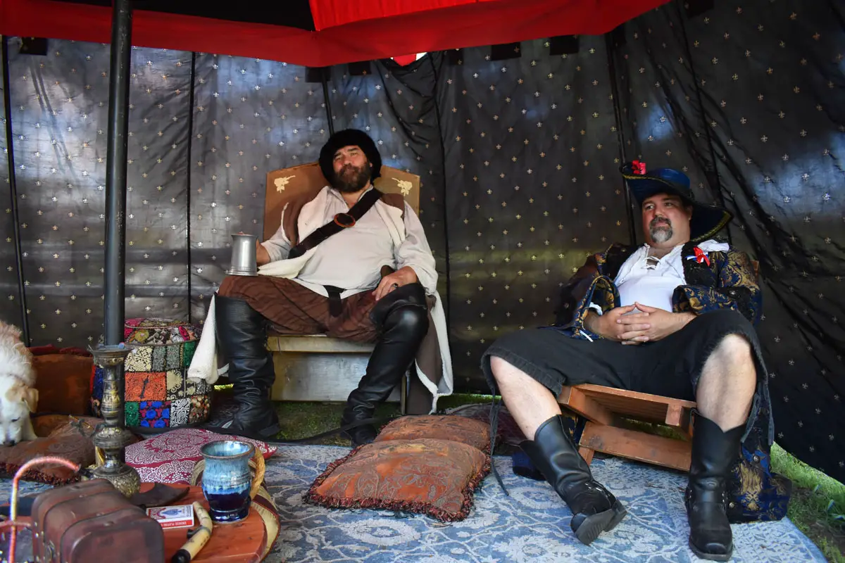 Two men find a relaxing "den" to put up their feet at the Escondido Renaissance Faire. Photo by Samantha Nelson