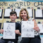 Luca Pollack, 9, a third grader at Pacific Rim Elementary School, and his teacher, Barbara Neslon show off his winning designs for the NASA Power to Explore Student Challenge. Photo by Steve Puterski