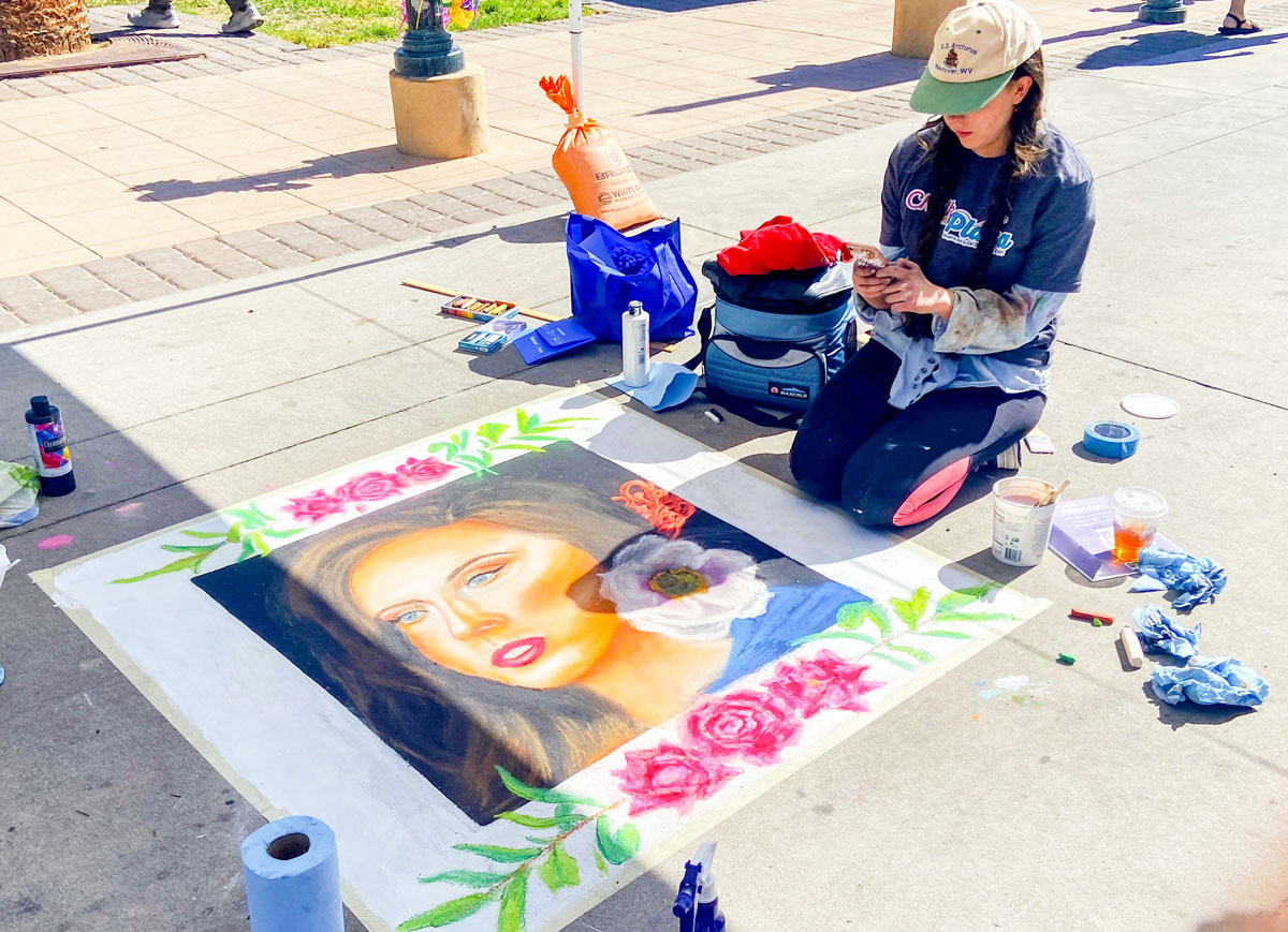 A young artist vies for the prize for her chalk art created during the first ¡mira! [cq] Las Cruces festival. The city of 112,000 in southern New Mexico has an active arts community – the Doña Ana Arts Council – which sponsors many programs for budding artists. Photo by E’Louise Ondash