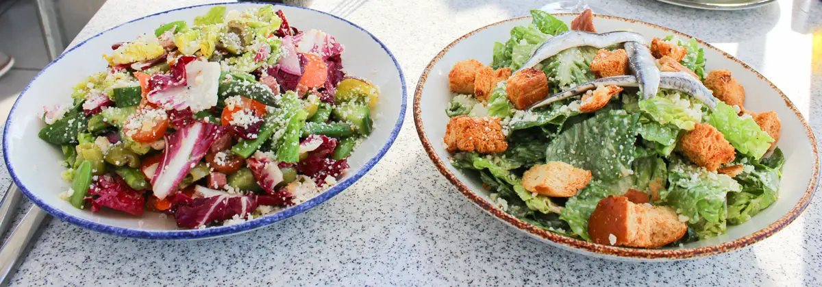 (Left to Right) Chopped salad and Classic Caesar Salad. Photo by Rico Cassoni.