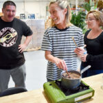 FutureStitch HR head Sarah Porter demonstrates how to make elderberry syrup to FutureStitch employees during an herbal medicine class. Photo by Samantha Nelson