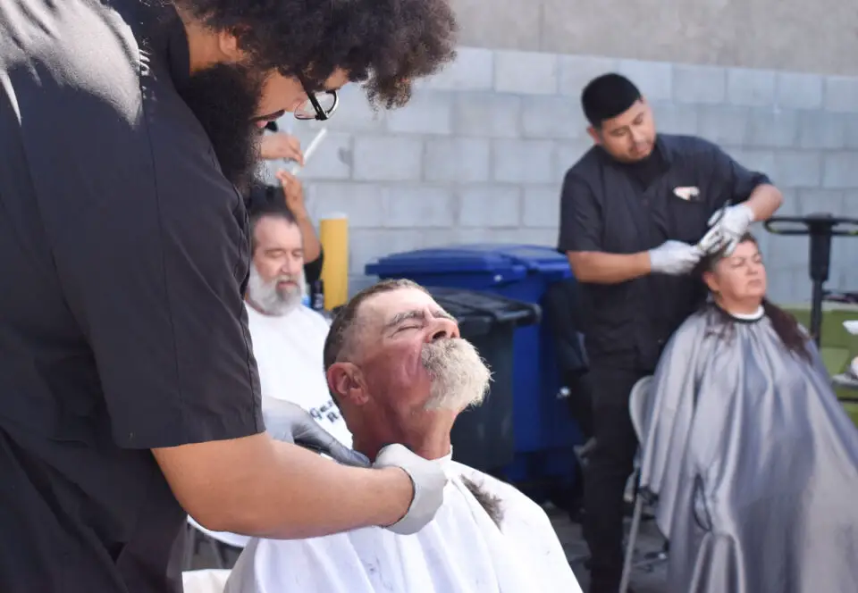 Students from Ivy League Barber Academy provide free haircuts at Neighborhood Healthcare’s Healthcare Day for the Homeless on Aug. 15 at Interfaith Community Services in Escondido. Photo by Samantha Nelson