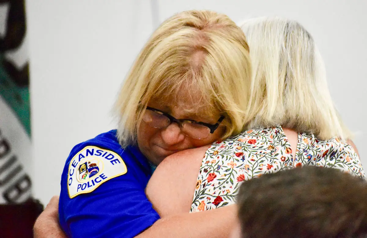 Heidi Sand hugs her mother, Jacque Martin, during Sand’s police swearing-in ceremony on Aug. 8. Photo by Samantha Nelson