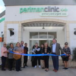 Members of the San Marcos City Council, Perlman Clinic staff and local residents celebrate the opening of the San Marcos Perlman Clinic location at Campus Marketplace on Wednesday. Photo by Laura Place