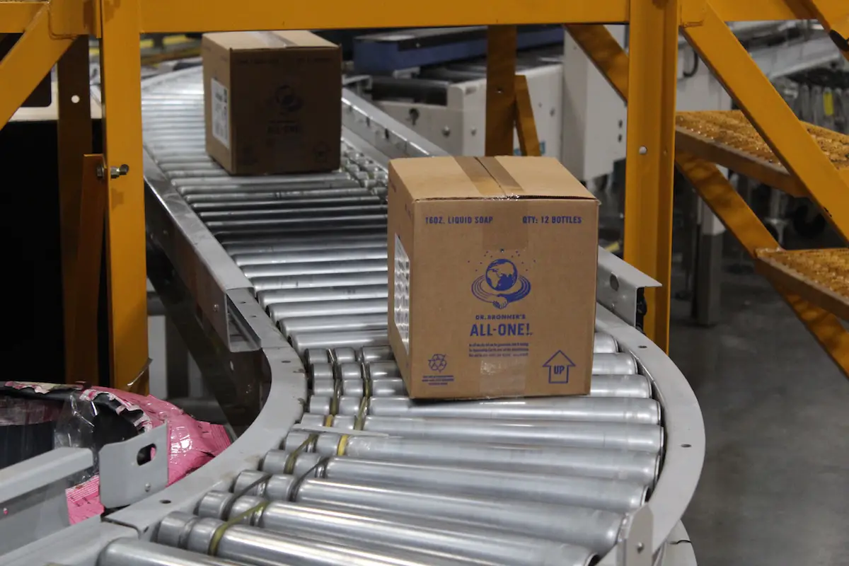 Boxes containing bottles of Dr. Bronner’ liquid soap are packaged and prepared for shipment at the company’s Vista factory. Photo by Laura Place