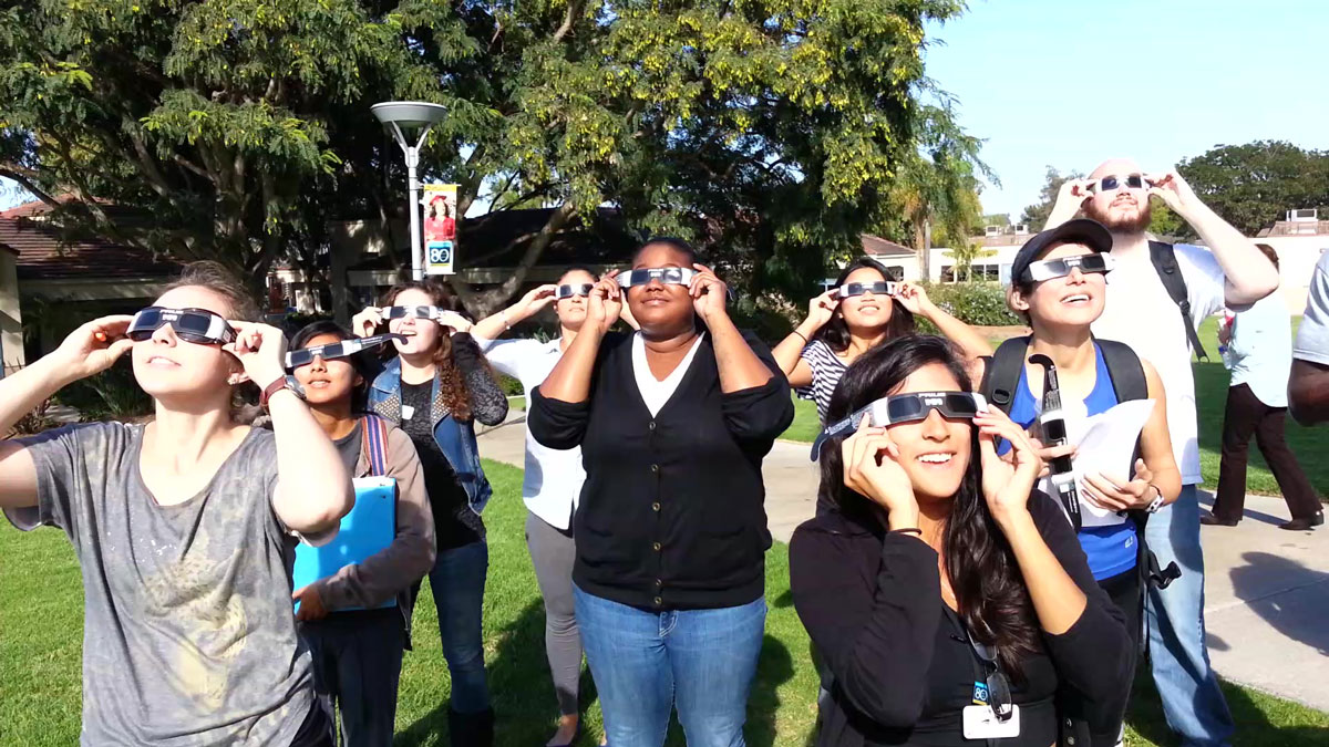 People of all ages gathered at MiraCosta College to view a partial solar eclipse on Oct. 23, 2014. Wearing special eclipse glasses is important to protect eyes from permanent damage. They must meet the ISO 12312-2 international standard. Photo courtesy of MiraCosta College
