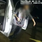 A screenshot depicting the juvenile male with a ghost gun in his hand attempting to flee from Carlsbad Police officers. Screenshot